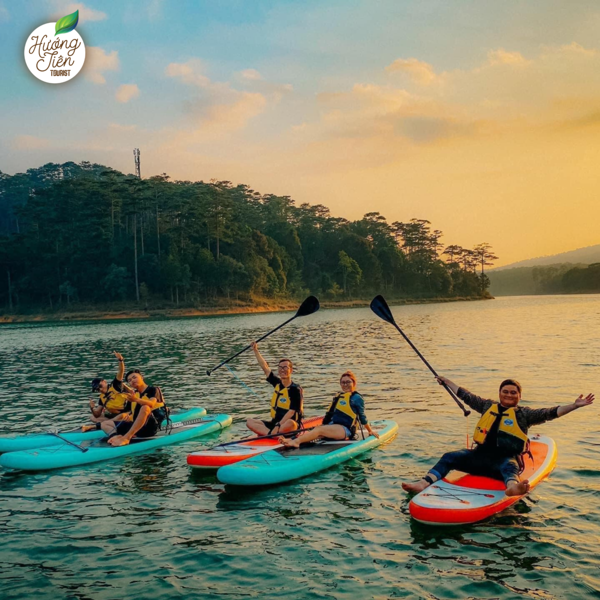 Da Lat Land Tour SUP rowing activity on Tuyen Lam Lake, surrounded by serene mountain and forest landscapes.