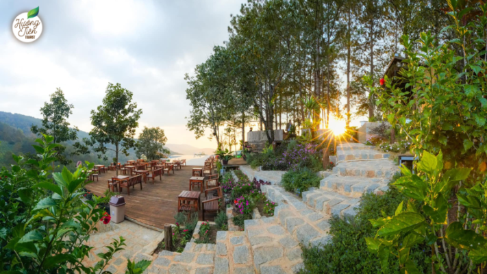 Da Lat Land Tour cafe with scenic mountain views, surrounded by lush greenery and peaceful ambiance.