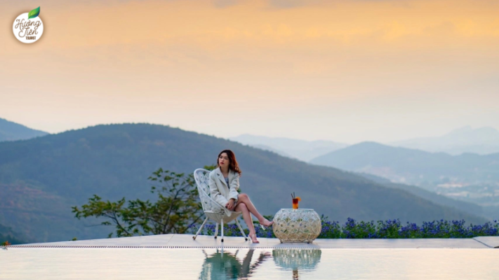 Visitor relaxing at a resort in Dalat with a mountain backdrop, showcasing peaceful experiences in the Dalat Land Tour