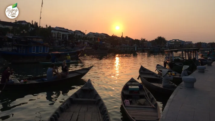 Fishing boats on the river in Hoi An at sunset, capturing the charm of this ancient Vietnamese trading port.