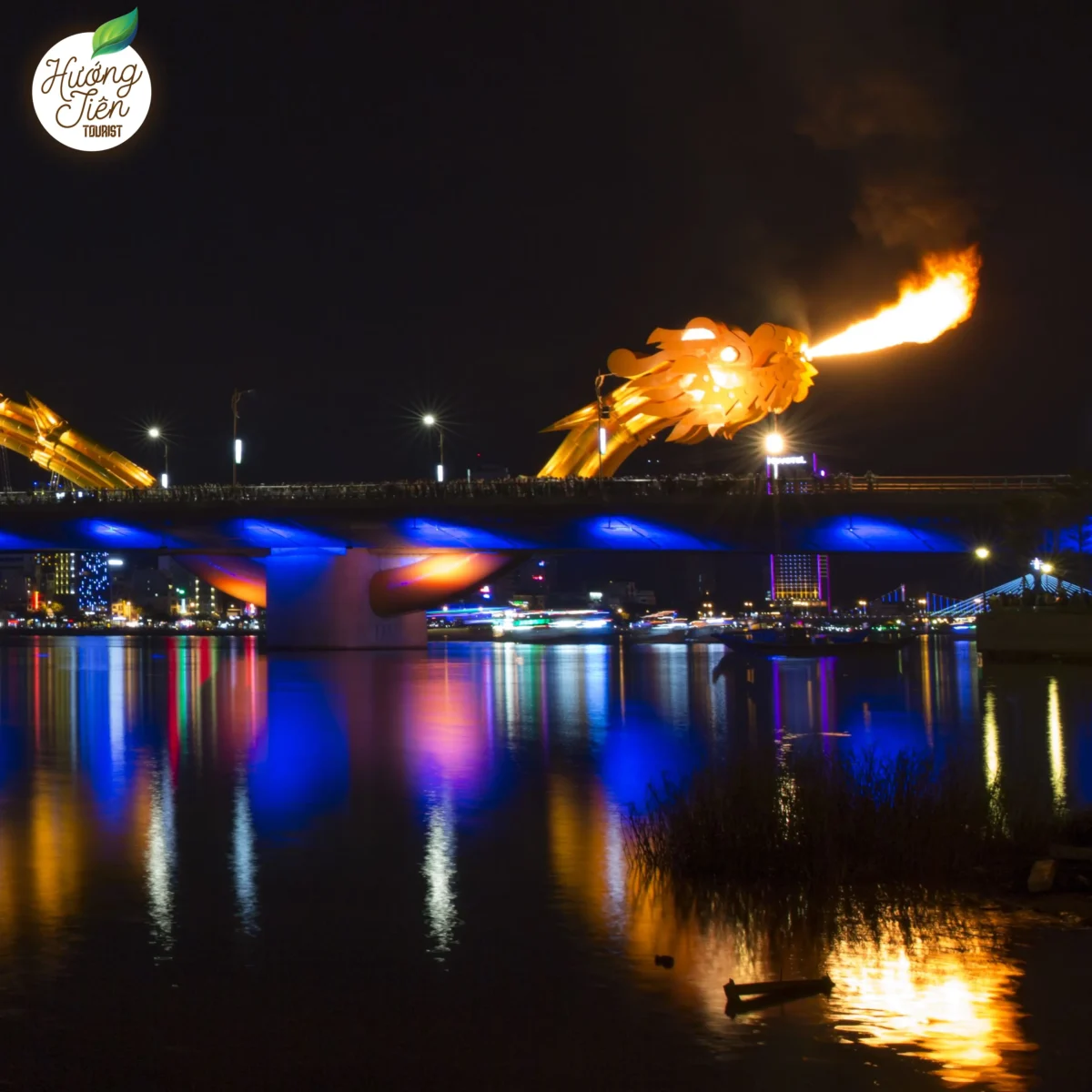 Night view of Dragon Bridge in Da Nang, Vietnam, as it breathes fire, a popular tourist attraction and iconic landmark.